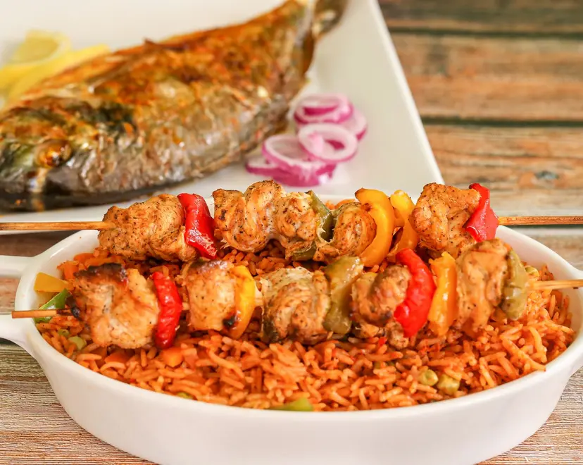 Jollof rice with grilled skewers and fish