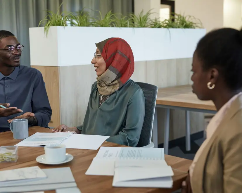 People from different backgrounds in conversation around a table