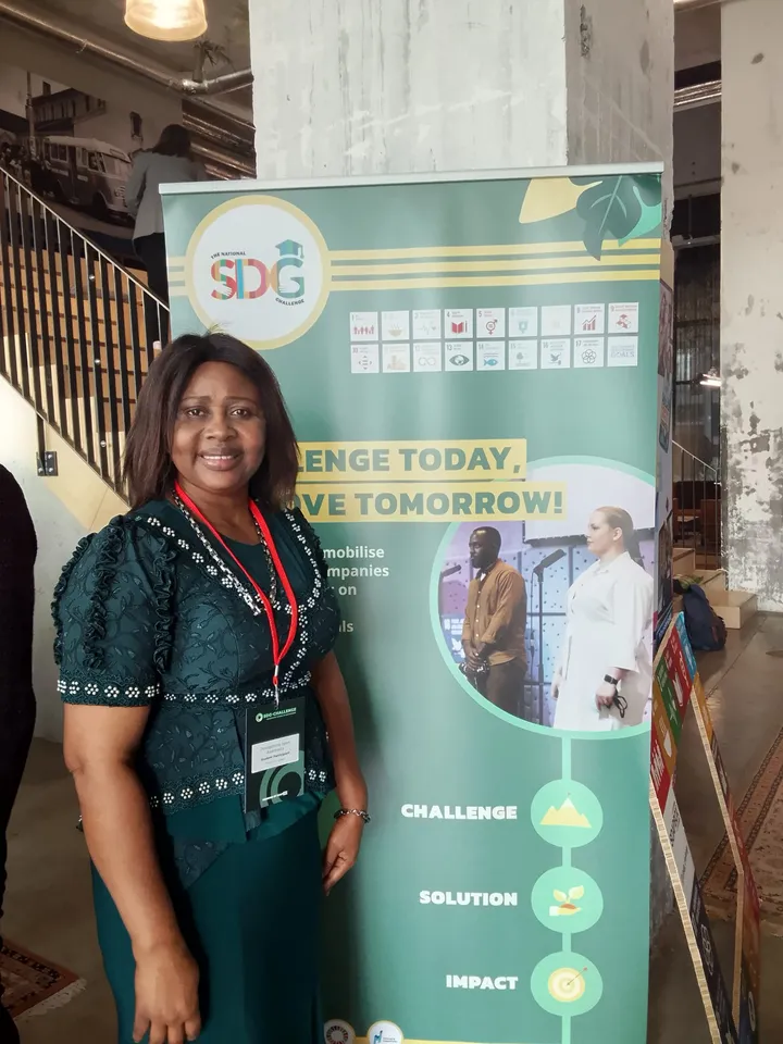 Josephine Asemota beside the Soapbox SDG Challenge banner