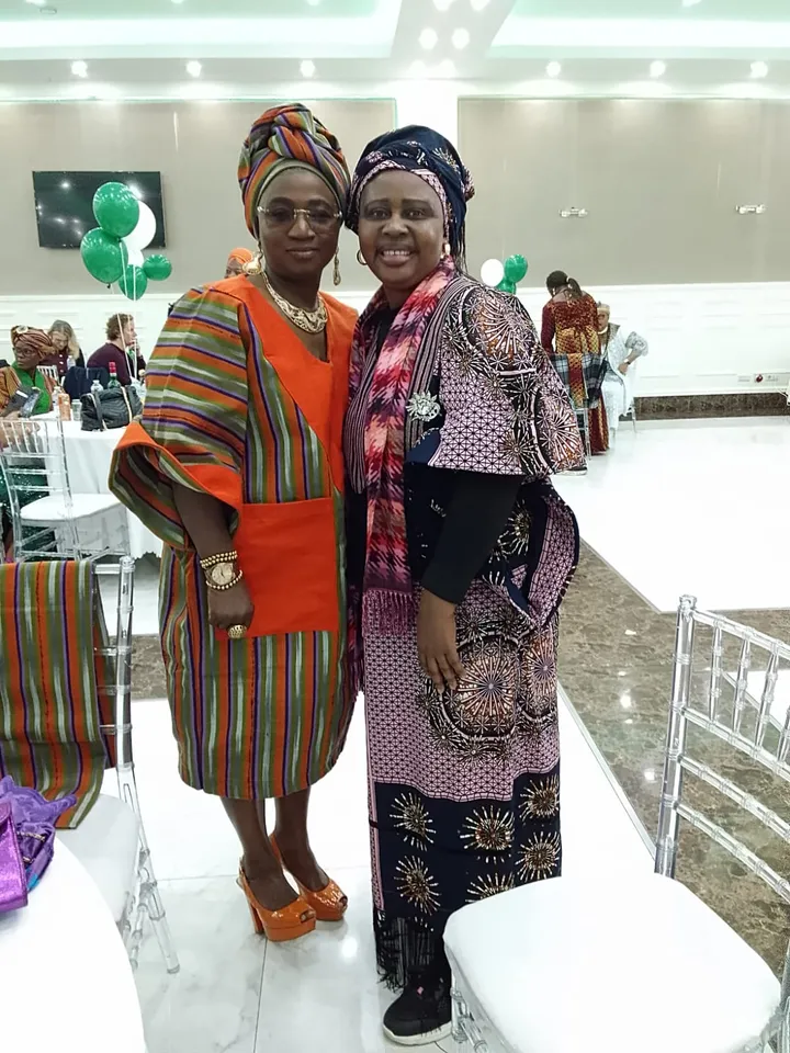 Two women in traditional Nigerian attire at a cultural celebration